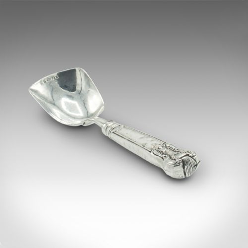 fig 3. An 18th-century English sterling silver sugar spoon featuring a square shovel-shaped bowl and a shell motif handle.