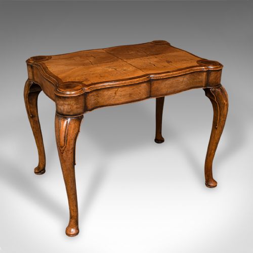 fig 1. An antique English walnut occasional lamp table featuring a quarter-veneered serpentine top, shaped frieze, and cabriole legs.