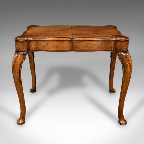 fig 2. An antique English walnut occasional lamp table featuring a quarter-veneered serpentine top, shaped frieze, and cabriole legs.
