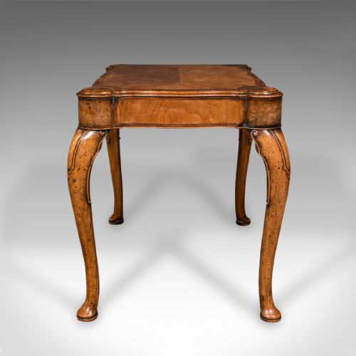 fig 3. An antique English walnut occasional lamp table featuring a quarter-veneered serpentine top, shaped frieze, and cabriole legs.