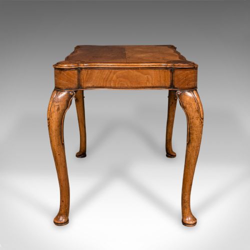 fig 4. An antique English walnut occasional lamp table featuring a quarter-veneered serpentine top, shaped frieze, and cabriole legs.