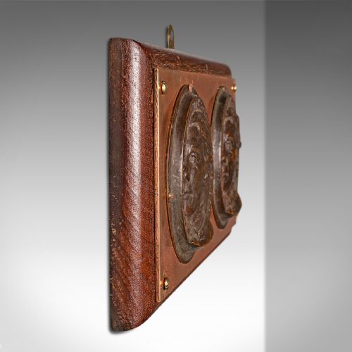 fig 2. A late Victorian mounted portrait plaque featuring two circular bronze profile medallions set on a copper plate with a mahogany timber mount.