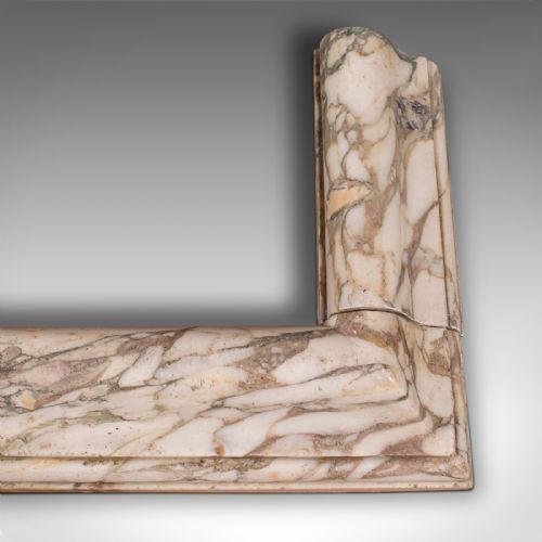 fig 3. A three-sided Georgian marble fireplace fender featuring heavily veined cream and grey stone with moulded upper edges.