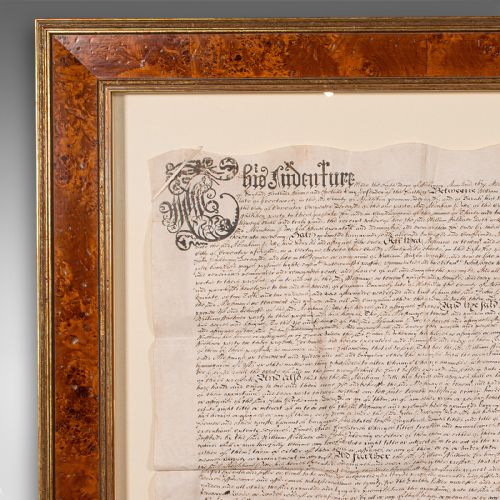 fig 3. A seventeenth-century handwritten vellum indenture with a wax seal, presented inside a light mount and a wide burr wood style frame.