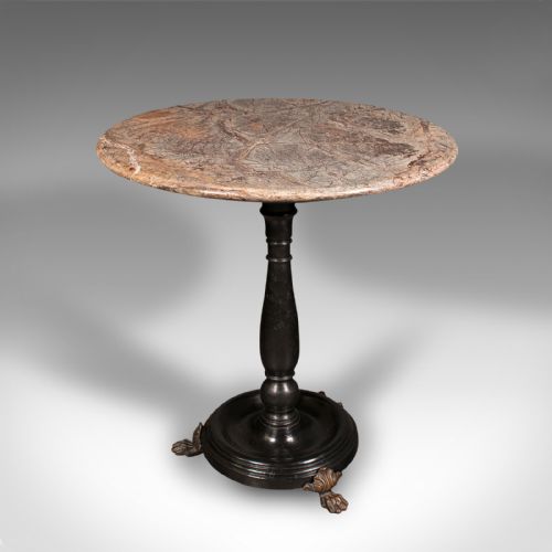 fig 2. A circular veined marble top resting upon a dark turned wooden pedestal stem with a round plinth base and three brass claw feet.