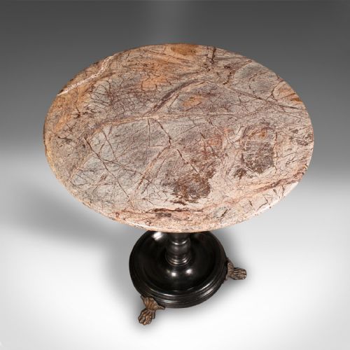 fig 3. A circular veined marble top resting upon a dark turned wooden pedestal stem with a round plinth base and three brass claw feet.