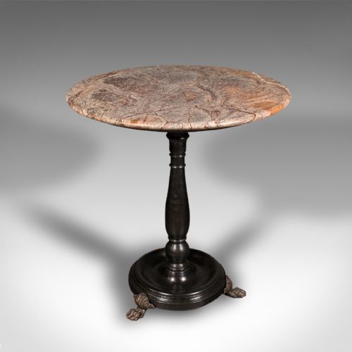 fig 4. A circular veined marble top resting upon a dark turned wooden pedestal stem with a round plinth base and three brass claw feet.