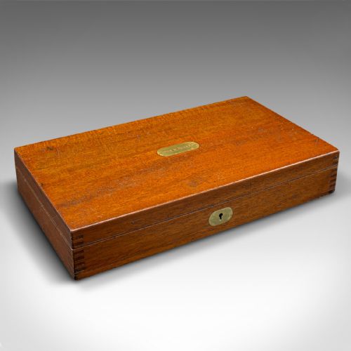 fig 1. An open mahogany wood box with a purple velvet lining containing an array of antique brass drafting compasses and ruling pens.