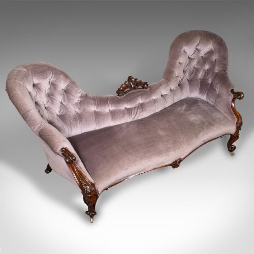 fig 5. An early Victorian double spoon back settee upholstered in mauve velvet with a carved timber frame and cabriole legs.