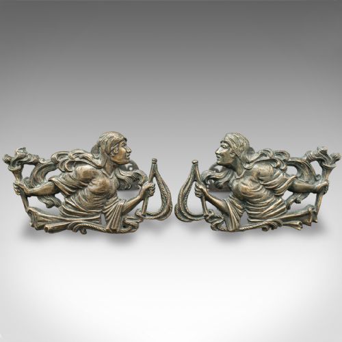 fig 1. A pair of mid-19th century French bronze figural andirons featuring sculpted classical figures holding torches with iron hearth supports behind.