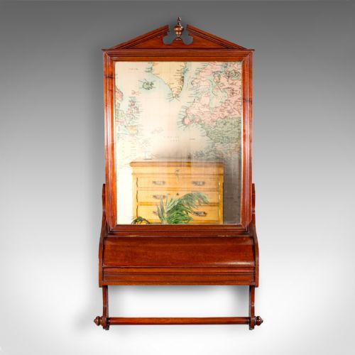 fig 2. A Victorian mahogany wall-mounted valet mirror featuring a pediment top, rectangular glass plate, cylinder glove box, and lower hanging rail.