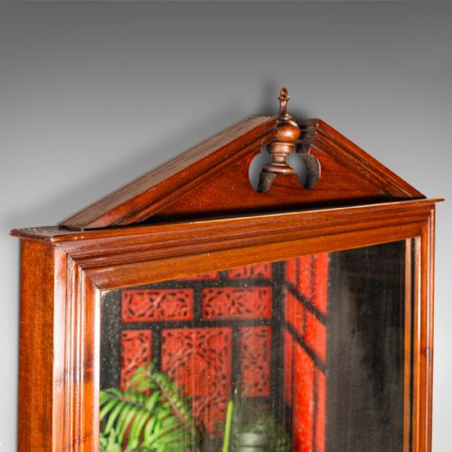 fig 4. A Victorian mahogany wall-mounted valet mirror featuring a pediment top, rectangular glass plate, cylinder glove box, and lower hanging rail.