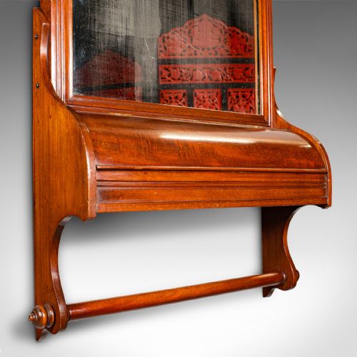 fig 5. A Victorian mahogany wall-mounted valet mirror featuring a pediment top, rectangular glass plate, cylinder glove box, and lower hanging rail.