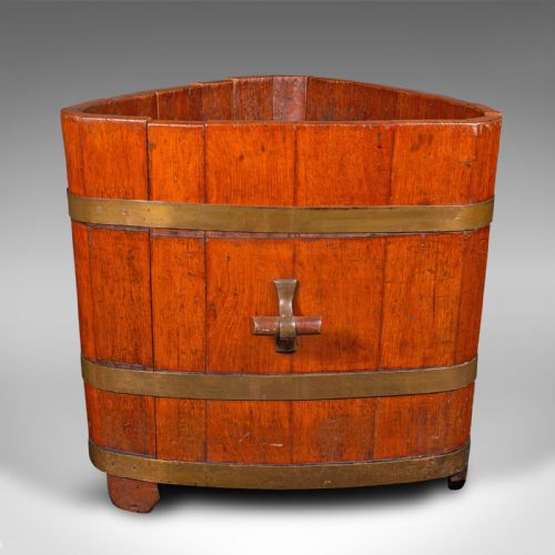 fig 1. An Early Victorian triangular wooden fireside bin constructed with staves bound by brass bands and side carrying handles.