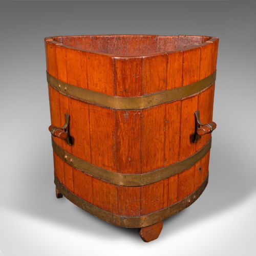 fig 3. An Early Victorian triangular wooden fireside bin constructed with staves bound by brass bands and side carrying handles.