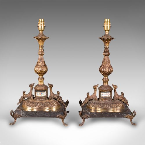 fig 1. A pair of ornate French gilt metal table lamp bases mounted on black veined marble plinths with scrolled feet.