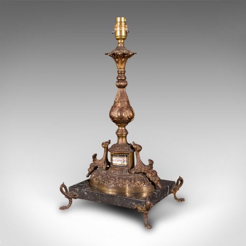 fig 4. A pair of ornate French gilt metal table lamp bases mounted on black veined marble plinths with scrolled feet.