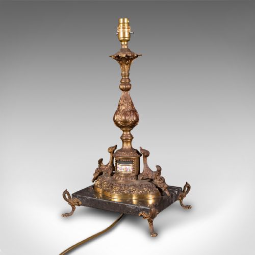 fig 5. A pair of ornate French gilt metal table lamp bases mounted on black veined marble plinths with scrolled feet.