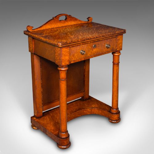 fig 1. An antique burr maple writing desk featuring a scrolled back gallery, a pull-out drawer with a red leather inset skiver, turned column supports, and a shaped plinth base.