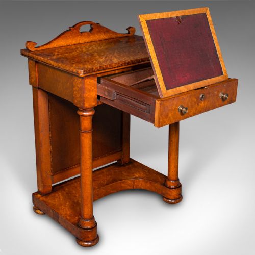 fig 2. An antique burr maple writing desk featuring a scrolled back gallery, a pull-out drawer with a red leather inset skiver, turned column supports, and a shaped plinth base.