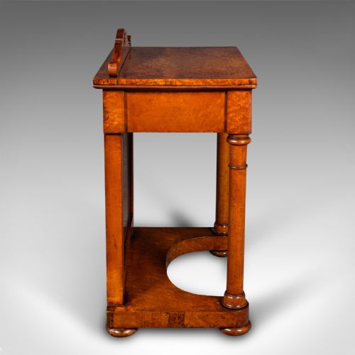 fig 4. An antique burr maple writing desk featuring a scrolled back gallery, a pull-out drawer with a red leather inset skiver, turned column supports, and a shaped plinth base.