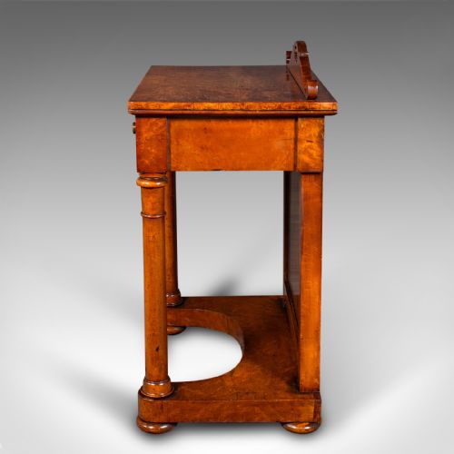 fig 5. An antique burr maple writing desk featuring a scrolled back gallery, a pull-out drawer with a red leather inset skiver, turned column supports, and a shaped plinth base.