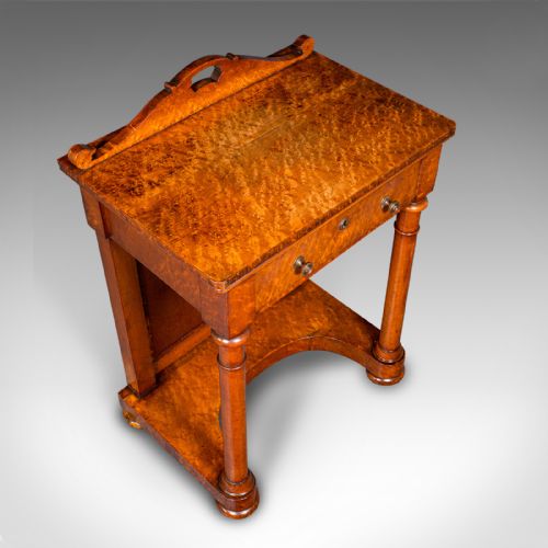 fig 7. An antique burr maple writing desk featuring a scrolled back gallery, a pull-out drawer with a red leather inset skiver, turned column supports, and a shaped plinth base.