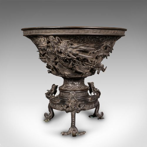 fig 3. A dark patinated Japanese bronze incense censer bowl featuring relief dragon carvings around the body and dragon-shaped tripod feet.