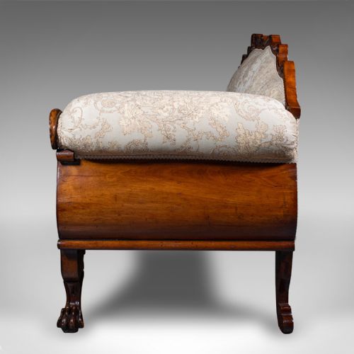 fig 3. A William IV carved mahogany settee featuring cream patterned damask upholstery, scroll arms, bolster cushions, and detailed paw feet.