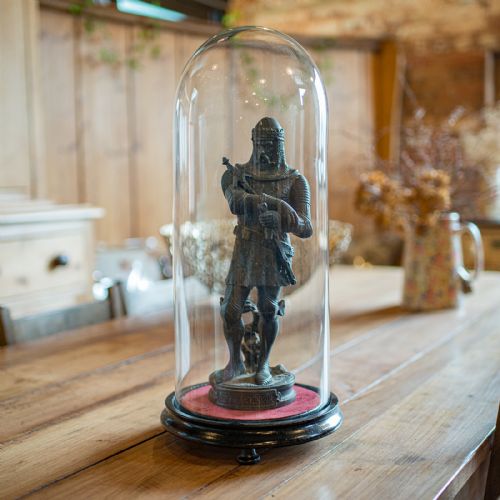fig 1. A tall clear glass dome set into a rounded ebonised wooden base with a red felt-lined interior surface.