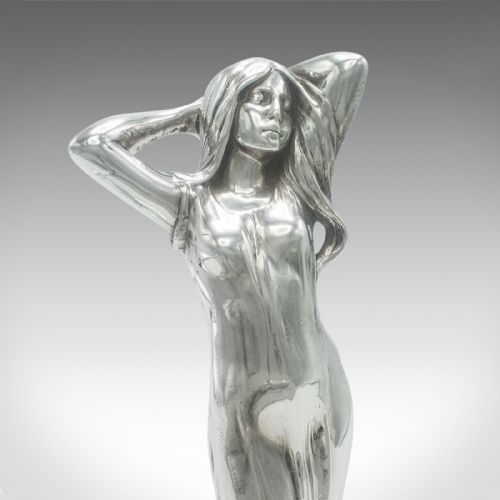 fig 4. A silver-toned Art Nouveau metal card tray featuring a central sculpted maiden figure with flowing hair standing atop a shaped lily pad base.