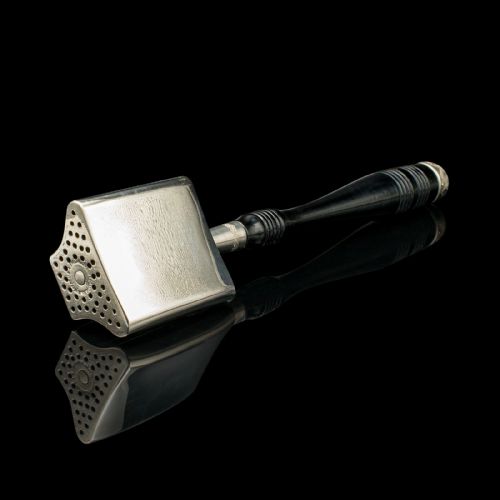fig 5. A nickel-plated McDonalds rotary hat iron with a black turned handle displayed next to its original printed cardboard box against a dark reflective surface.