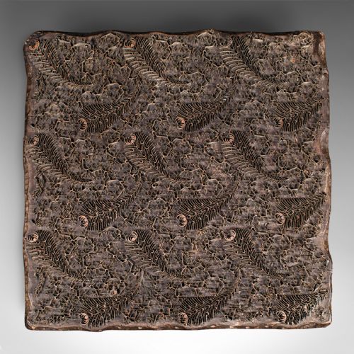 fig 2. A square dark hardwood textile printing block featuring intricate inlaid metal foliage and fern patterns.
