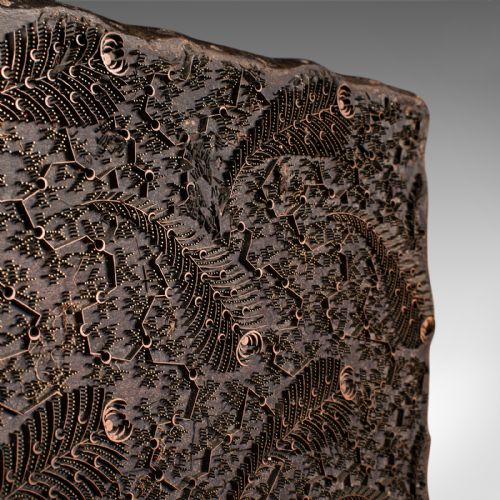 fig 4. A square dark hardwood textile printing block featuring intricate inlaid metal foliage and fern patterns.