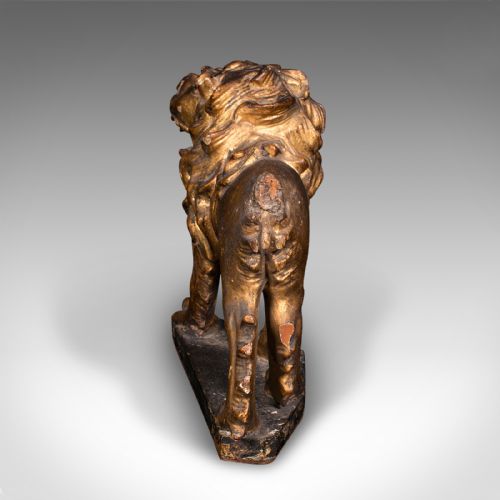 fig 3. A carved Mid-Georgian giltwood lion figure standing on a dark rectangular base with a detailed mane and open mouth.