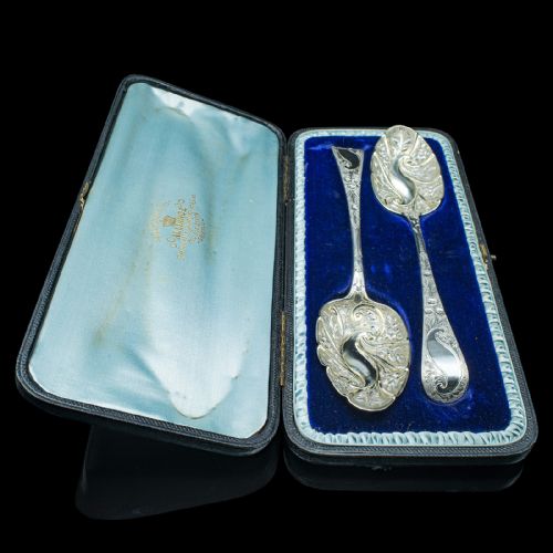 fig 4. A pair of antique Georgian hallmarked sterling silver dessert spoons with ornate repousse foliage decoration in the bowls and stems.