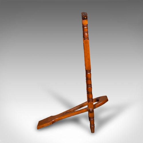 fig 3. A Victorian walnut standing boot jack featuring turned upright supports, a top handlebar, and a folding foot-operated boot pull mechanism.
