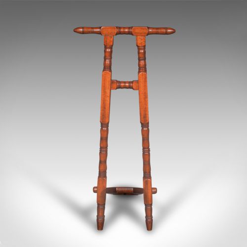fig 4. A Victorian walnut standing boot jack featuring turned upright supports, a top handlebar, and a folding foot-operated boot pull mechanism.