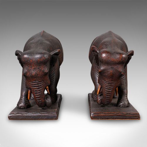 fig 2. A pair of hand-carved dark hardwood bookends shaped like elephants standing on rectangular wooden bases.