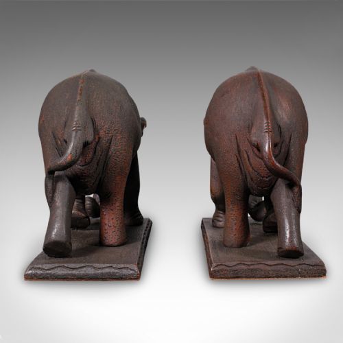 fig 3. A pair of hand-carved dark hardwood bookends shaped like elephants standing on rectangular wooden bases.