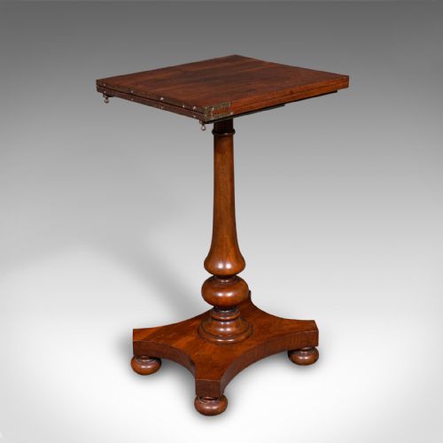 fig 1. An antique mahogany calligraphers table featuring a hinged cantilevered top supported by a turned pedestal column and a plinth base with compressed ball feet.