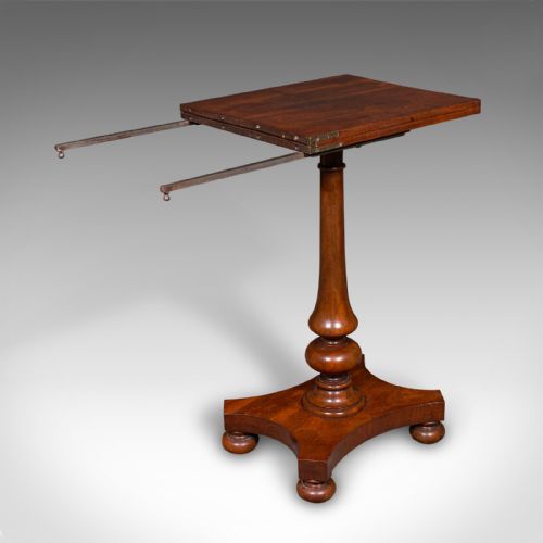 fig 2. An antique mahogany calligraphers table featuring a hinged cantilevered top supported by a turned pedestal column and a plinth base with compressed ball feet.