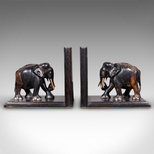 fig 1. Pair of Victorian Anglo-Indian coromandel wood bookends featuring carved elephant figures with bone tusks on L-shaped bases.