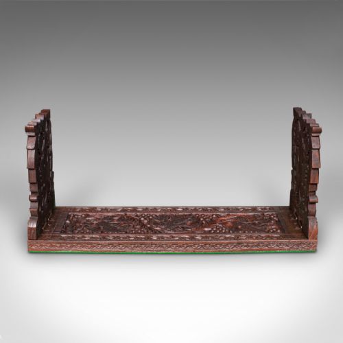 fig 2. An antique dark carved teak extending book slide featuring floral fretwork foldable ends and a carved base.