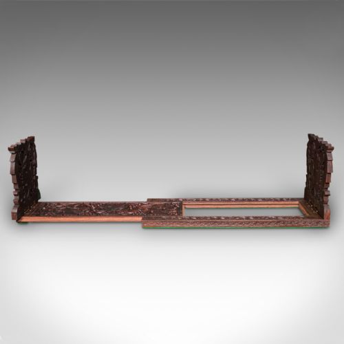 fig 3. An antique dark carved teak extending book slide featuring floral fretwork foldable ends and a carved base.
