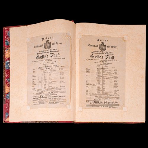 fig 2. A large antique book bound in red leather and marbled brown paper with gold gilt detailing along the spine.
