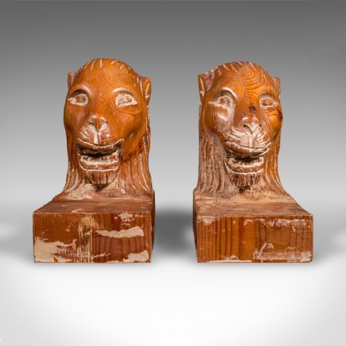 fig 1. A pair of hand-carved pine bookends featuring lion heads set on rectangular wooden bases with prominent grain details.