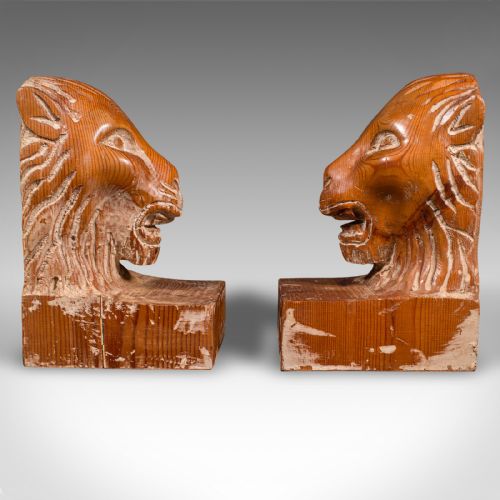 fig 2. A pair of hand-carved pine bookends featuring lion heads set on rectangular wooden bases with prominent grain details.