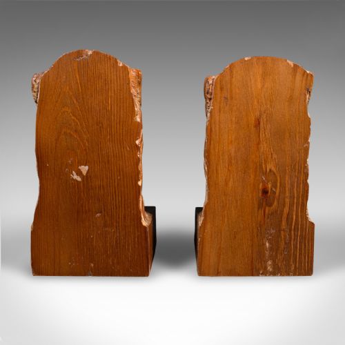 fig 3. A pair of hand-carved pine bookends featuring lion heads set on rectangular wooden bases with prominent grain details.