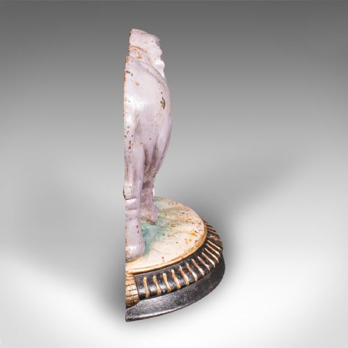 fig 2. A Victorian cast iron doorstop depicting an elephant with its trunk raised standing on a painted oval base.